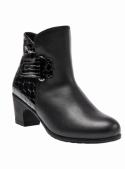 Botín de cuero negro para mujer, estilo casual chic, mezcla de elegancia y modernidad con detalles únicos.