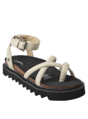 Calzado de cuero beige para mujer con suela gruesa dentada tipo track sole, ideal para un look audaz y contemporáneo.